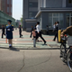 North Korean men and women walk along a residential area in Pyongyang, North Korea on April 25, 2017 (AP Photo/Eric Talmadge)